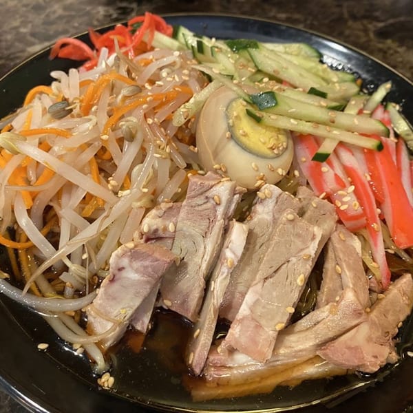 Daiichi Ramen's cold ramen with pork, egg, crab sticks, cucumbers, and bean sprouts.